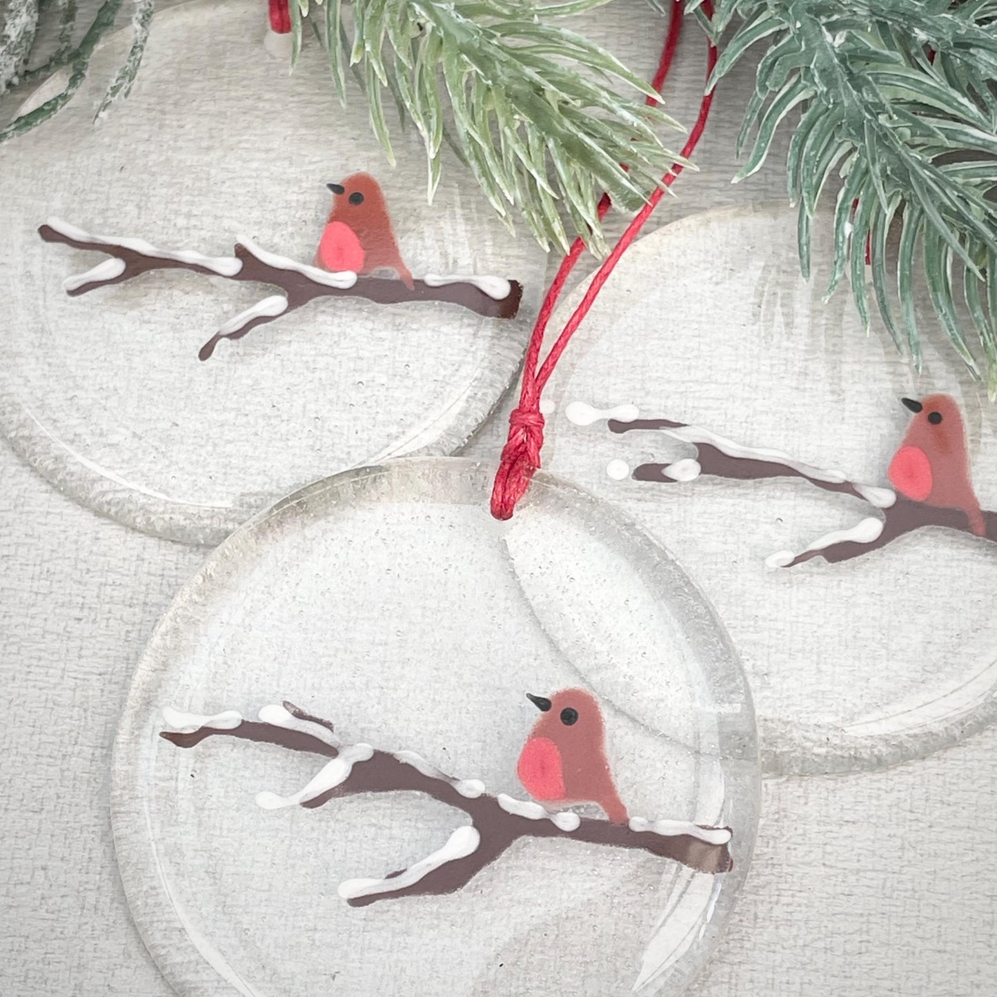 Robin on a snowy branch - round hanger